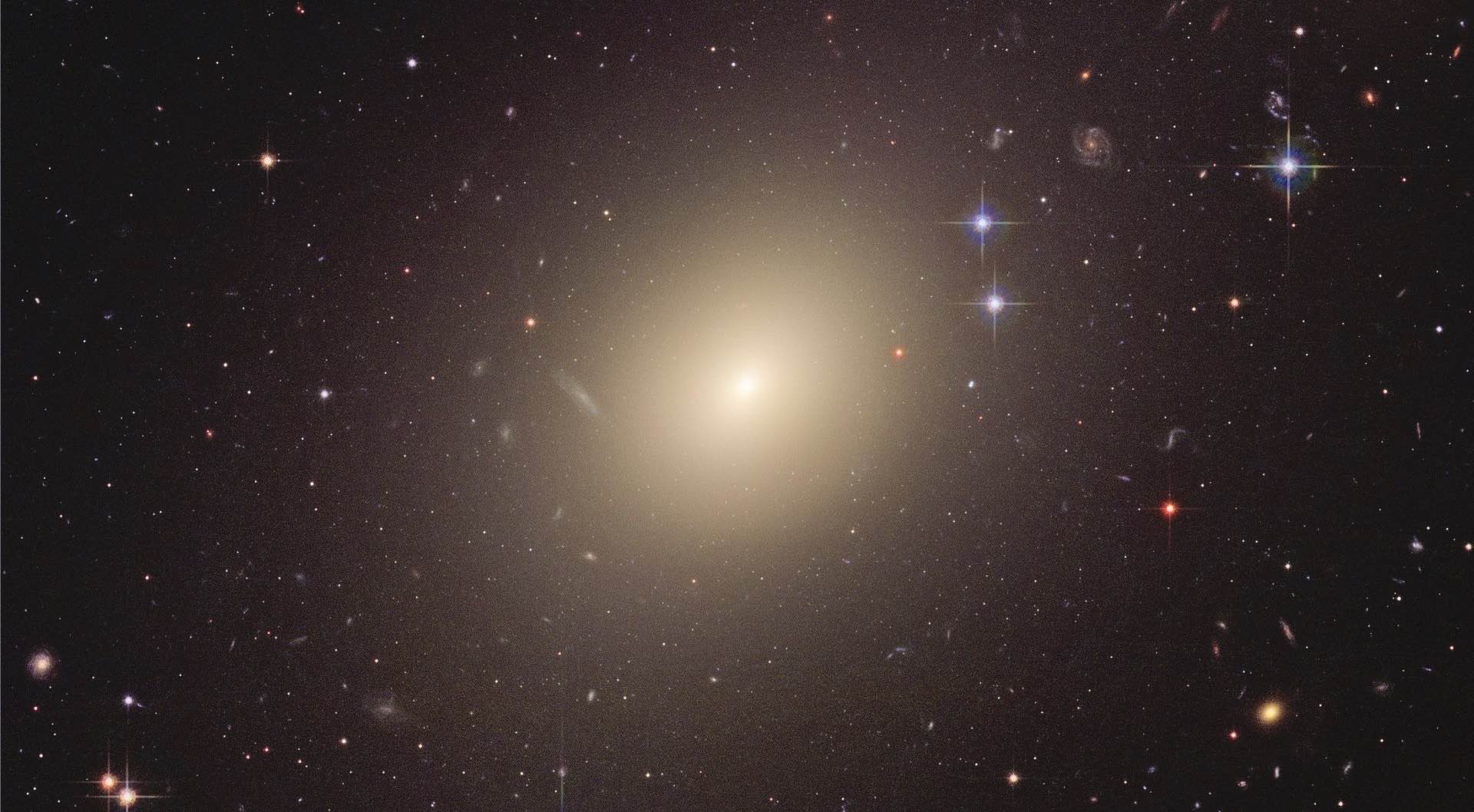 The giant elliptical galaxy ESO 325-G004. Like most other elliptical galaxies, ESO 325-G004 has virtually ceased forming new stars, so that only the old, orange/reddish stars are left, giving the elliptical galaxies their characteristic color (credit: NASA, ESA, and The Hubble Heritage Team).